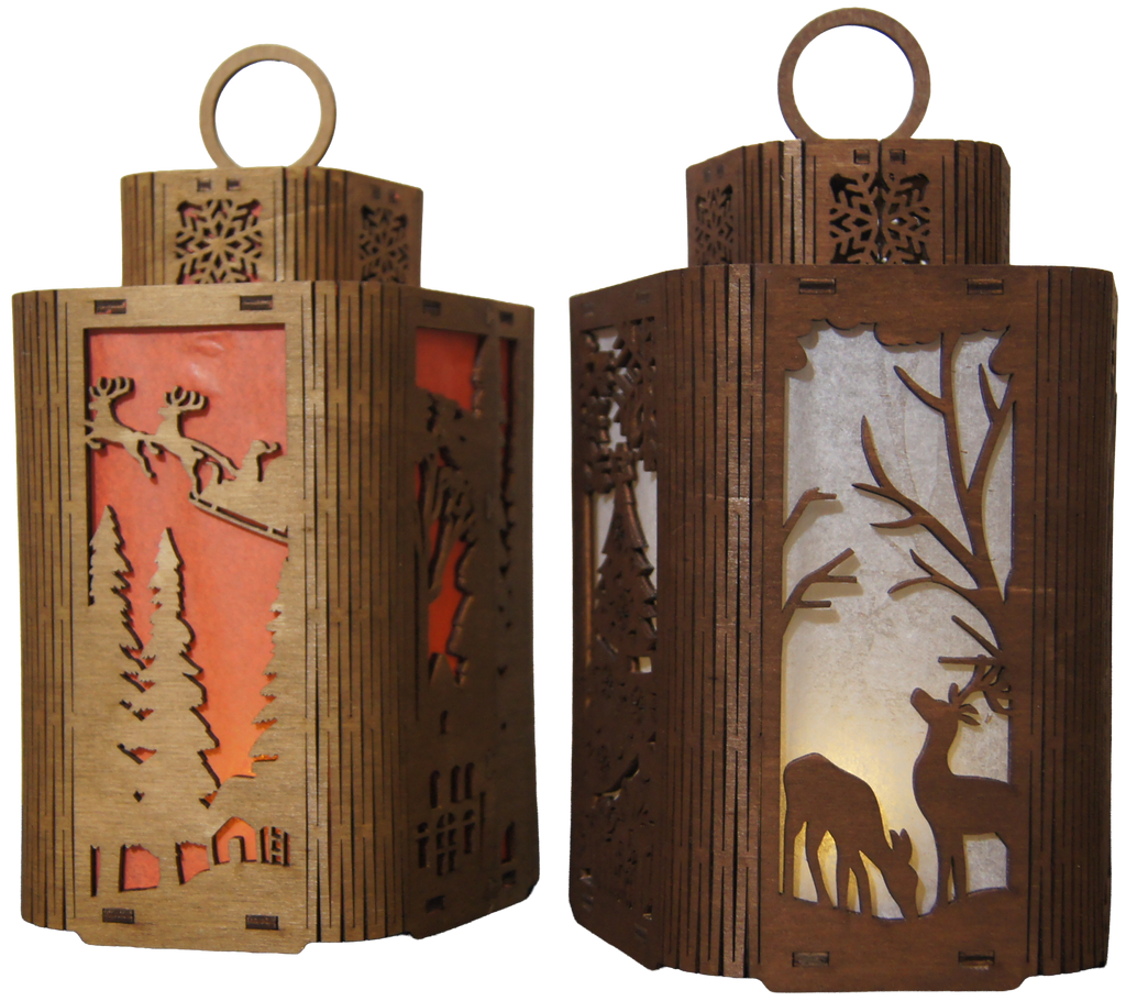 Two intricately designed wooden lanterns are displayed side by side. One features a festive scene with reindeer against a red background, while the other showcases a serene forest with a deer silhouette on a light-colored backdrop.