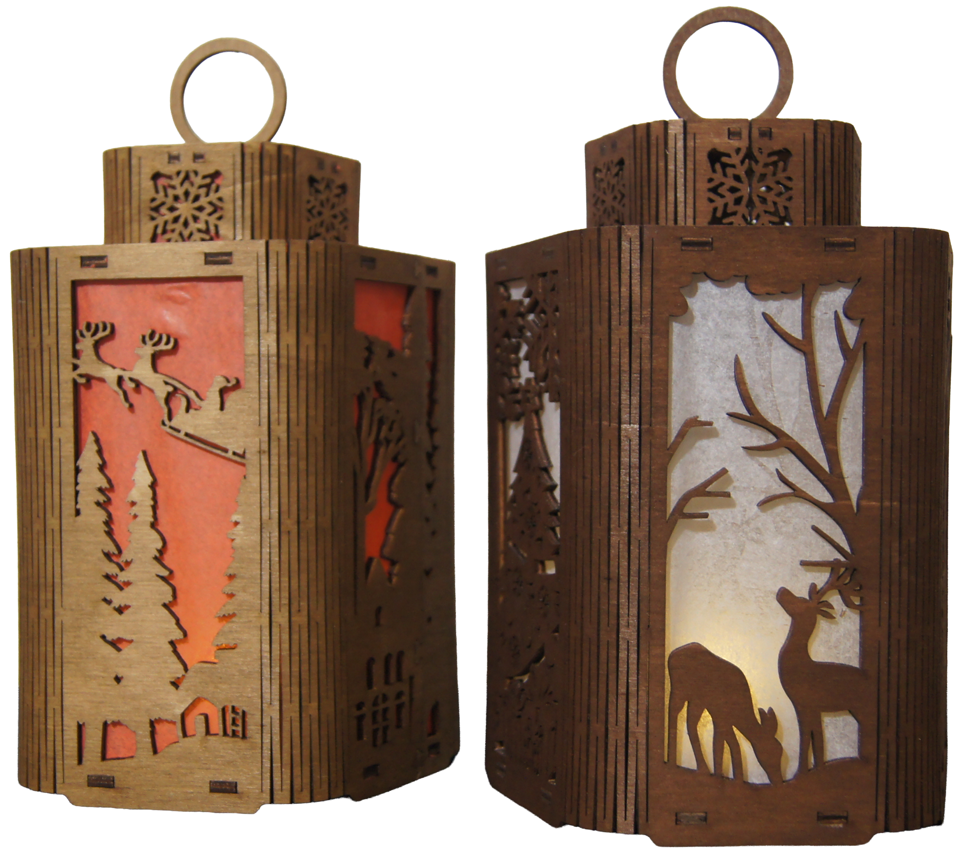 Two intricately designed wooden lanterns are displayed side by side. One features a festive scene with reindeer against a red background, while the other showcases a serene forest with a deer silhouette on a light-colored backdrop.